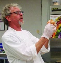 Chef Kent holds up veggies